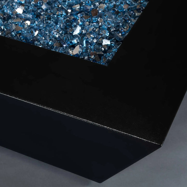 Detail view of Starfire Designs Mill 48-inch square gas fire pit in Black Hammertone finish, highlighting the smooth, modern steel surface and shimmering blue fire glass.