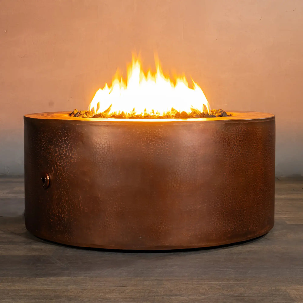 Starfire Designs Moreno 36-inch round copper fire pit with flames, showcasing the rich hammered copper finish and glowing fire, perfect for creating a warm and luxurious ambiance in outdoor setting