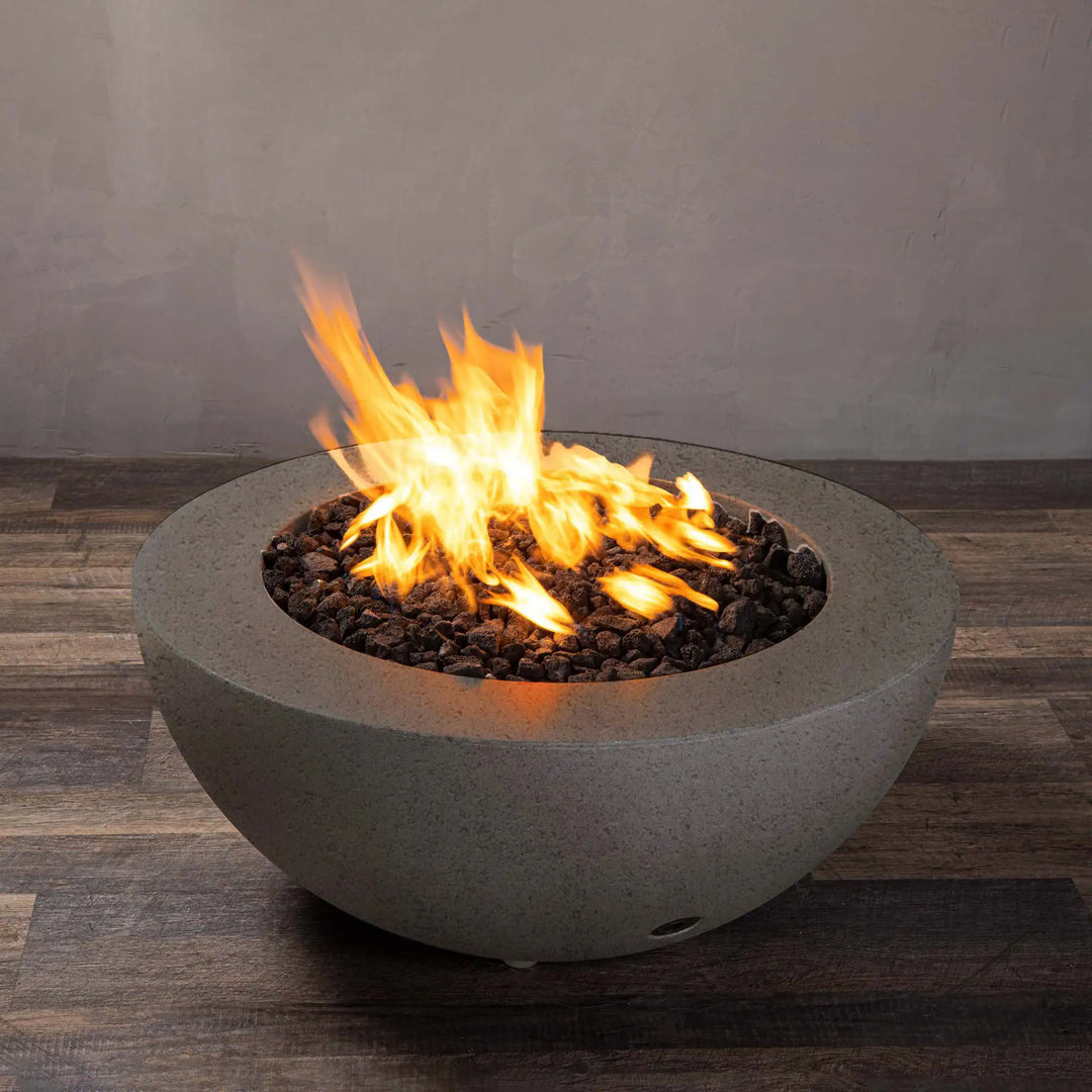 Side view of the Starfire Designs Rustic 36-inch Round Concrete Gravity Gas Fire Pit in brown, featuring a modern design with a glowing flame