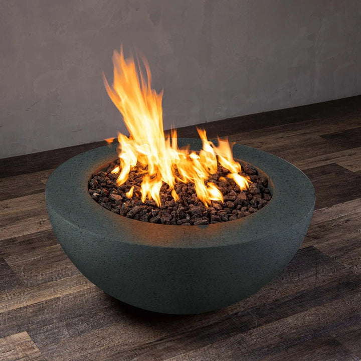 Side view of graphite Starfire Designs Rustic 36-inch round concrete gravity gas fire pit with active flames, perfect for modern outdoor spaces