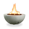 Starfire Designs Rustic 36-inch Round Concrete Gravity Gas Fire Pit in Natural Gray with full flame in a white background setting.