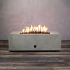 Starfire Designs Rustic 45-inch round concrete Gravity gas fire pit in beige with flame on, creating a warm and inviting atmosphere for outdoor gatherings