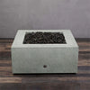 Back view of the Starfire Designs Rustic Gravity 36-inch Square Concrete Gas Fire Pit in Natural Gray, showcasing the durable concrete structure and natural lava rocks