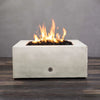 Starfire Designs Rustic Gravity 36-inch Square Concrete Gas Fire Pit in White with vibrant flames, ideal for outdoor ambiance