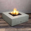 Side angle view of the Starfire Designs Rustic Gravity 45-inch square concrete gas fire pit in natural gray. The fire pit showcases a sleek and robust design, offering a luxurious addition to any patio or outdoor living area