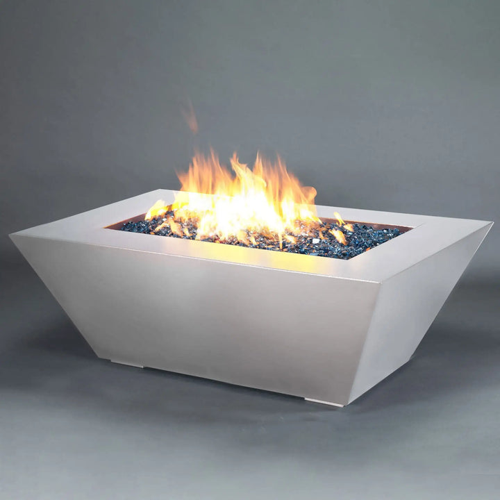 The Starfire Designs Steel Mill 60" x 32" Rectangle Gas Fire Pit in white hammertone with a vibrant, mesmerizing flame. This photo captures the stunning contrast between the bright flames and the sleek, modern fire pit design, perfect for both warmth and ambiance in any outdoor setting