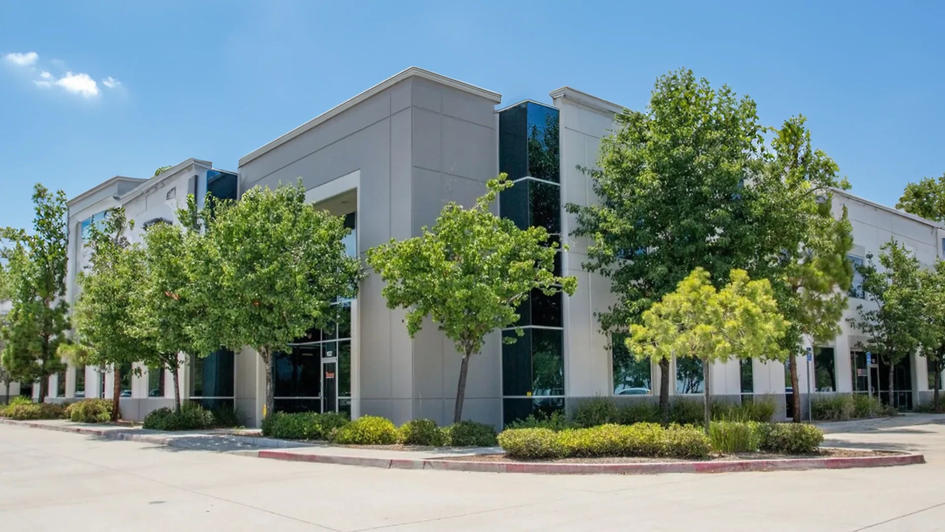 Starfire Direct headquarters located in Temecula, CA, featuring a modern building with large windows and surrounding trees and landscaping.