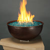 A stunning hammered copper fire bowl filled with Starfire Glass 1/2" Broken Fire Glass (10lbs) in Pacific Blue Reflective. The vibrant blue reflective fire glass enhances the flame’s brilliance, making it an eye-catching feature for any outdoor fire pit. The reflective surface maximizes light reflection, creating a luxurious ambiance. Ideal for fire bowls, propane fire pits, and modern outdoor spaces.