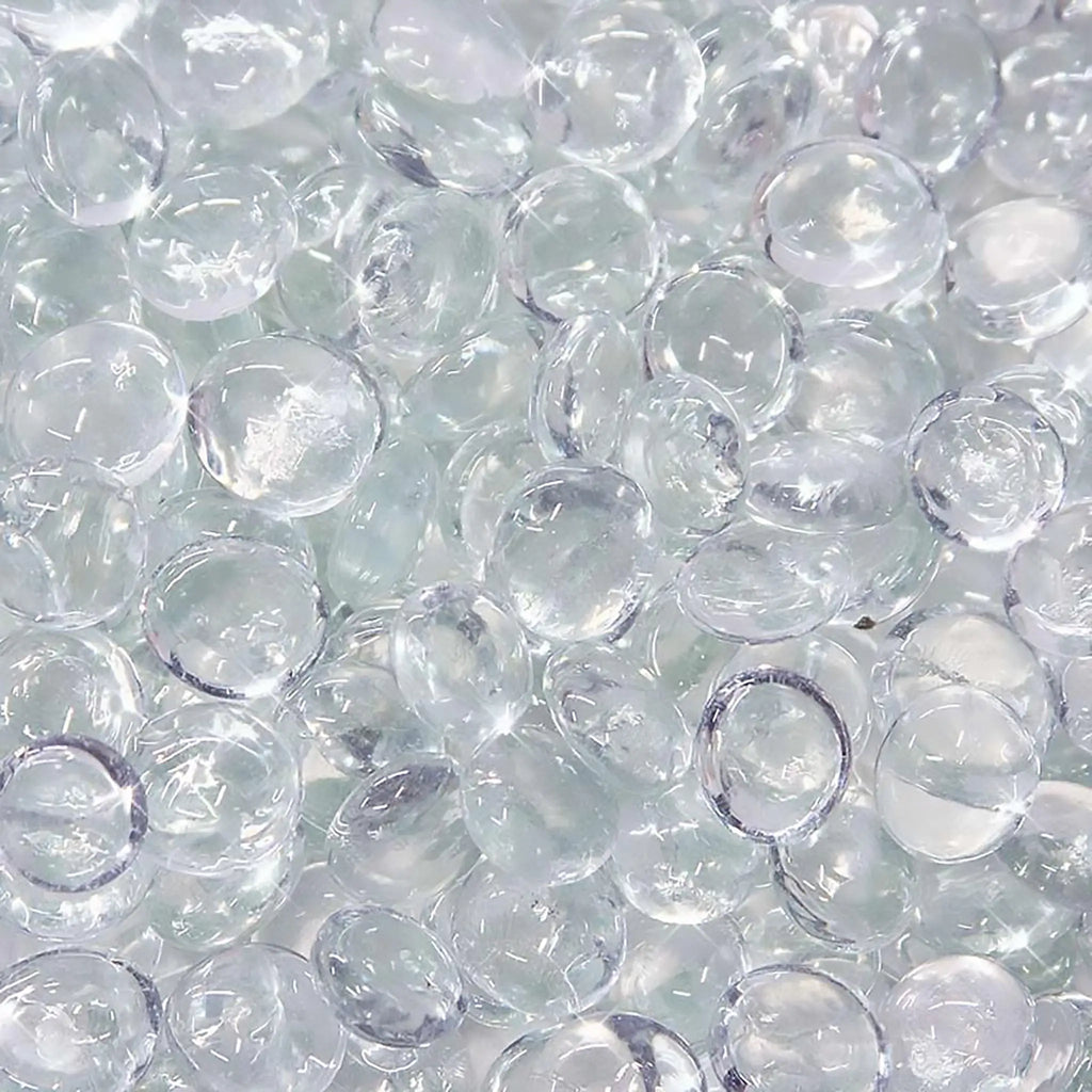 Close-up of Starfire Glass Reflective Fire Drops in Clear (10lbs), featuring crystal-clear, smooth, and polished heat-resistant fire glass. Enhances any fire pit, modern fire table, or outdoor fire feature with a shimmering effect.
