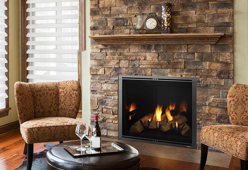 Elegant stone fireplace with a gas log burner, set in a cozy living room with classic armchairs and a warm ambiance. The traditional decor and soft lighting create an inviting space perfect for relaxation and enjoying the flickering fire.