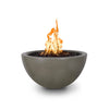 his image displays The Outdoor Plus 30" Luna Concrete Gas Fire Pit in the ash finish, with an active flame burning in the center. The fire pit's smooth, curved concrete design creates an elegant, minimalist aesthetic perfect for modern outdoor settings. The fire pit uses natural gas and features a dark-colored fire media that enhances the contrast with the ash-colored base. This fire pit is ideal for creating a warm, inviting ambiance in any backyard or patio space.