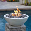  The Outdoor Plus 33" Round Concrete Sedona Fire Bowl in a white finish, featured by the poolside, with a bright flame burning over polished lava rocks (not included). This elegant outdoor fire and water bowl creates a stunning focal point, blending fire and water elements for luxurious backyard and patio settings. The high-quality concrete construction ensures durability, making it ideal for outdoor living spaces.