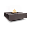 Angled view of The Outdoor Plus 36-inch Cabo Square Concrete Gas Fire Pit in chestnut color. This fire pit features a natural chestnut tone, perfect for rustic or contemporary patios. With its square shape and strong concrete structure, it complements outdoor seating areas and provides warmth with its gas-powered flames.