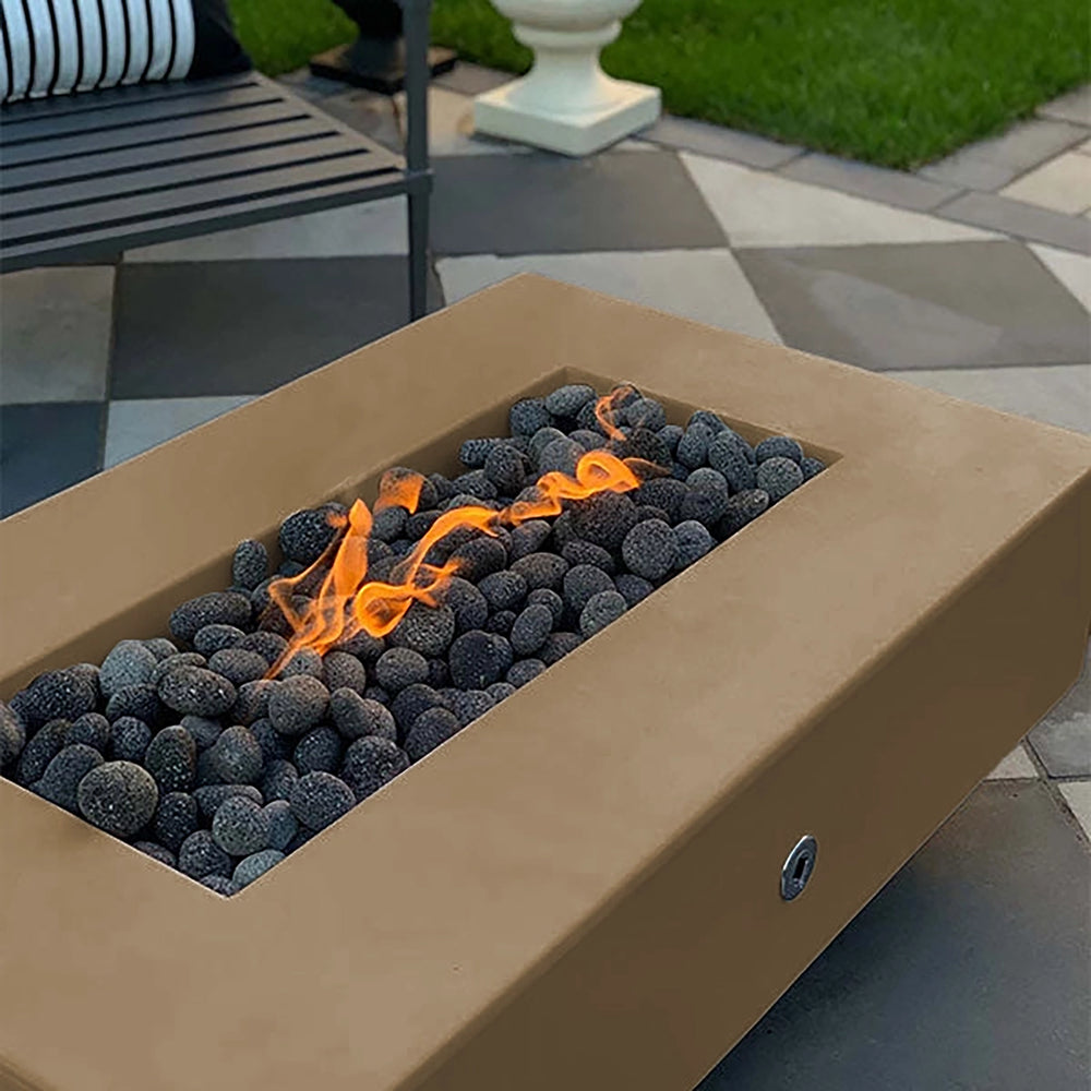 The Outdoor Plus 60-inch Del Mar Concrete Gas Fire Pit in a warm bronze finish, highlighting a rustic charm with vivid flames over black lava rocks. Crafted for outdoor elegance, this fire pit adds a touch of warmth and ambiance to patios and backyard settings.