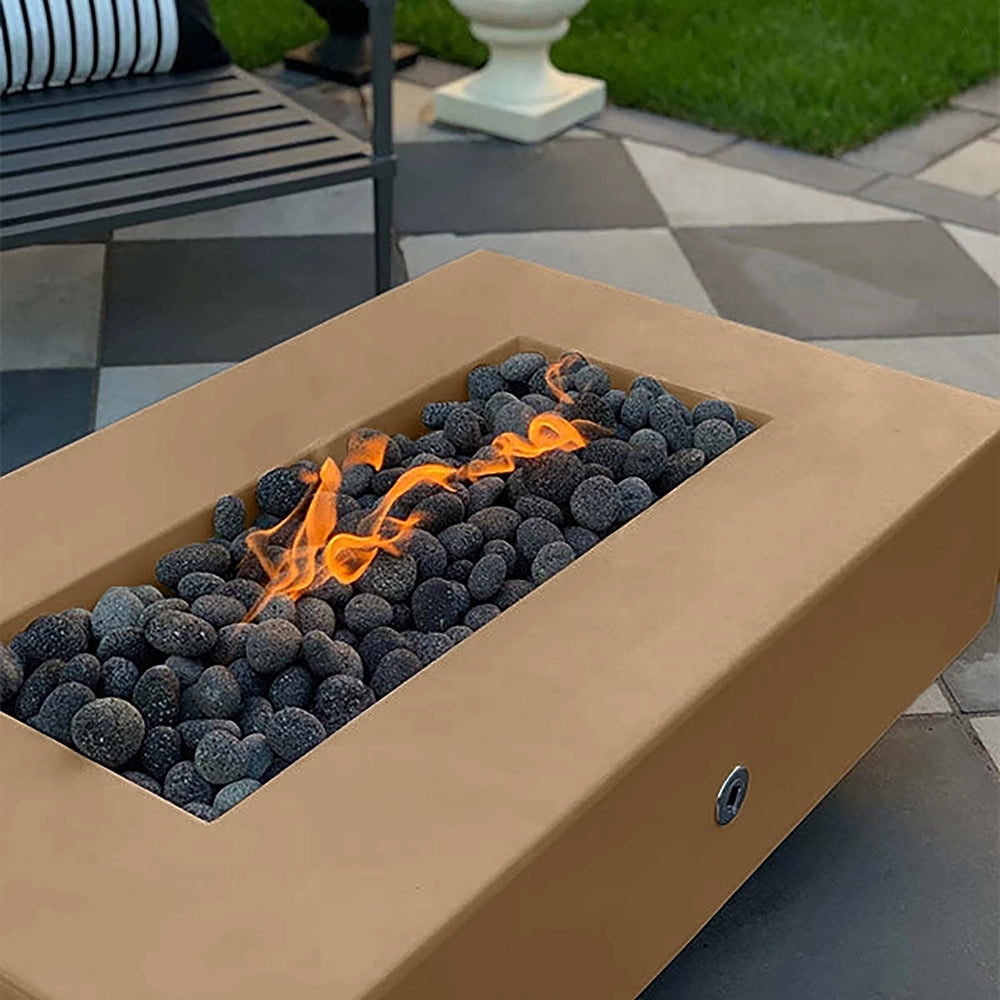 The Outdoor Plus 60-inch Del Mar Concrete Gas Fire Pit in an earthy brown shade, offering a cozy and inviting outdoor feature. This natural gas fire pit with dark lava rocks is designed for backyard gatherings, providing a welcoming glow for modern patios.