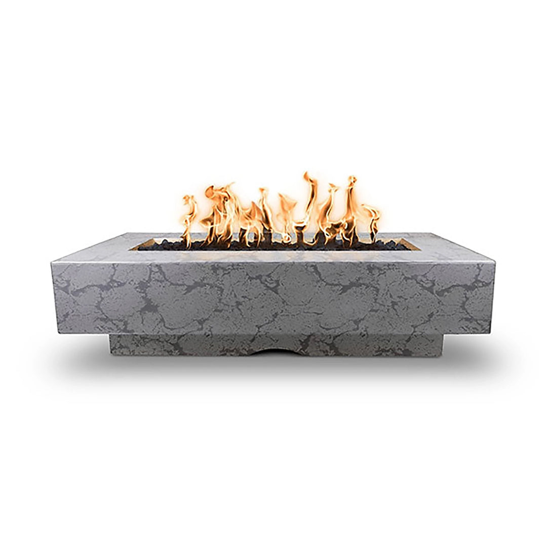 The Outdoor Plus 72-inch Del Mar concrete gas fire pit in rustic gray, displaying a marble-like pattern and rectangular structure with dancing flames. Adds a rustic charm to outdoor living areas, blending well with both modern and traditional aesthetics. Rustic gray finish enhances earthy tones in patio settings.