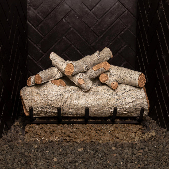 Real Fyre Mountain Birch vented gas logs, 24-inch size, unlit and set on a black grate. The detailed white birch logs offer a natural, rustic appearance, ideal for creating a cozy and realistic fireplace ambiance. Compatible with both natural gas and propane fireplaces, this set enhances the aesthetic appeal of any indoor setting.