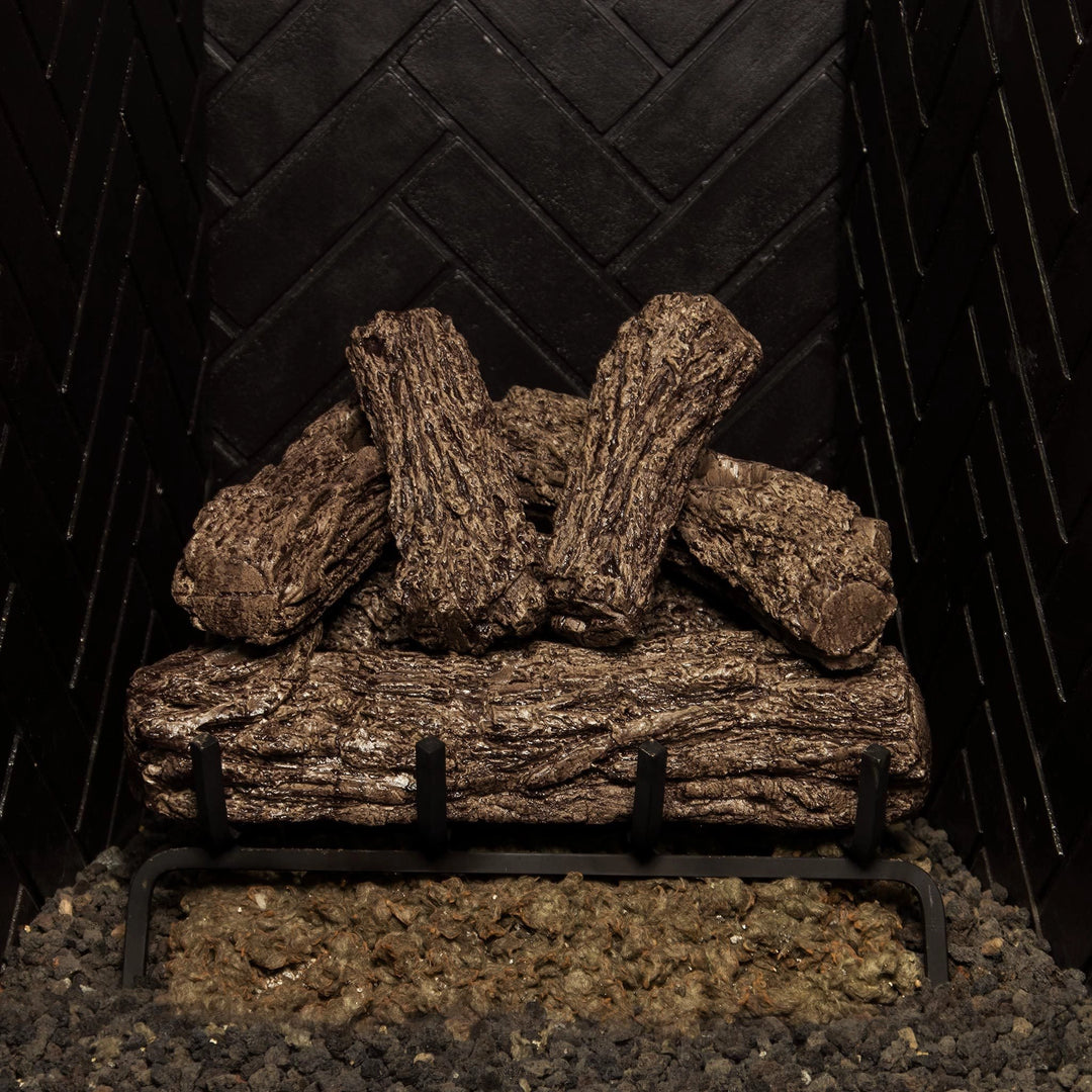 Real Fyre 16-inch Rustic Oak vented gas logs arranged on a black grate, featuring a rustic wood design ideal for vented natural gas fireplaces.