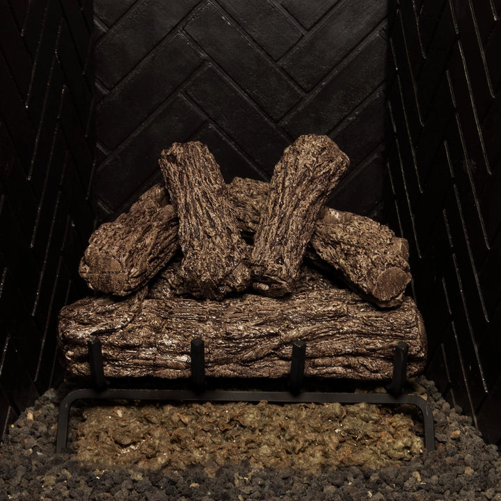 Real Fyre 16-inch Rustic Oak vented gas logs arranged on a black grate, featuring a rustic wood design ideal for vented natural gas fireplaces.