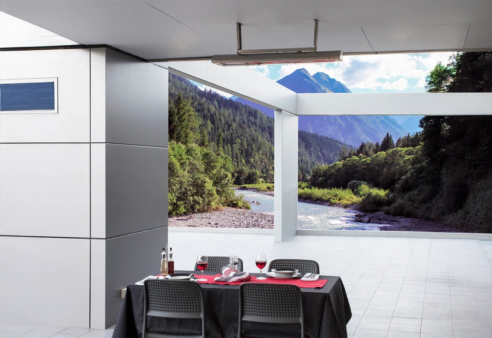 Sleek wall and ceiling mount heater providing warmth to a modern patio dining area with a stunning mountain and river view.