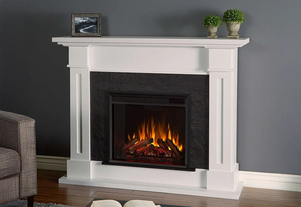 Classic white mantel electric fireplace with a black stone surround, featuring lifelike flames and glowing embers in a stylish living room setting.