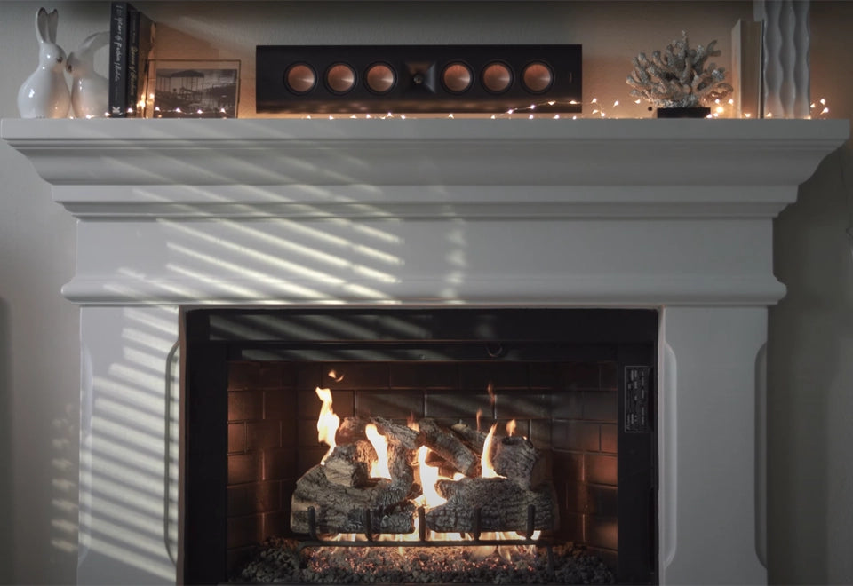 Elegant white mantel fireplace featuring a natural gas burner kit with realistic log set, surrounded by a classic brick firebox. The cozy flames and soft lighting create a warm and welcoming atmosphere, perfect for traditional and modern living spaces alike.